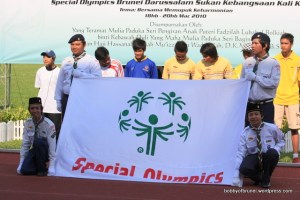 Scouts Volunteers holding up the special olympics banner